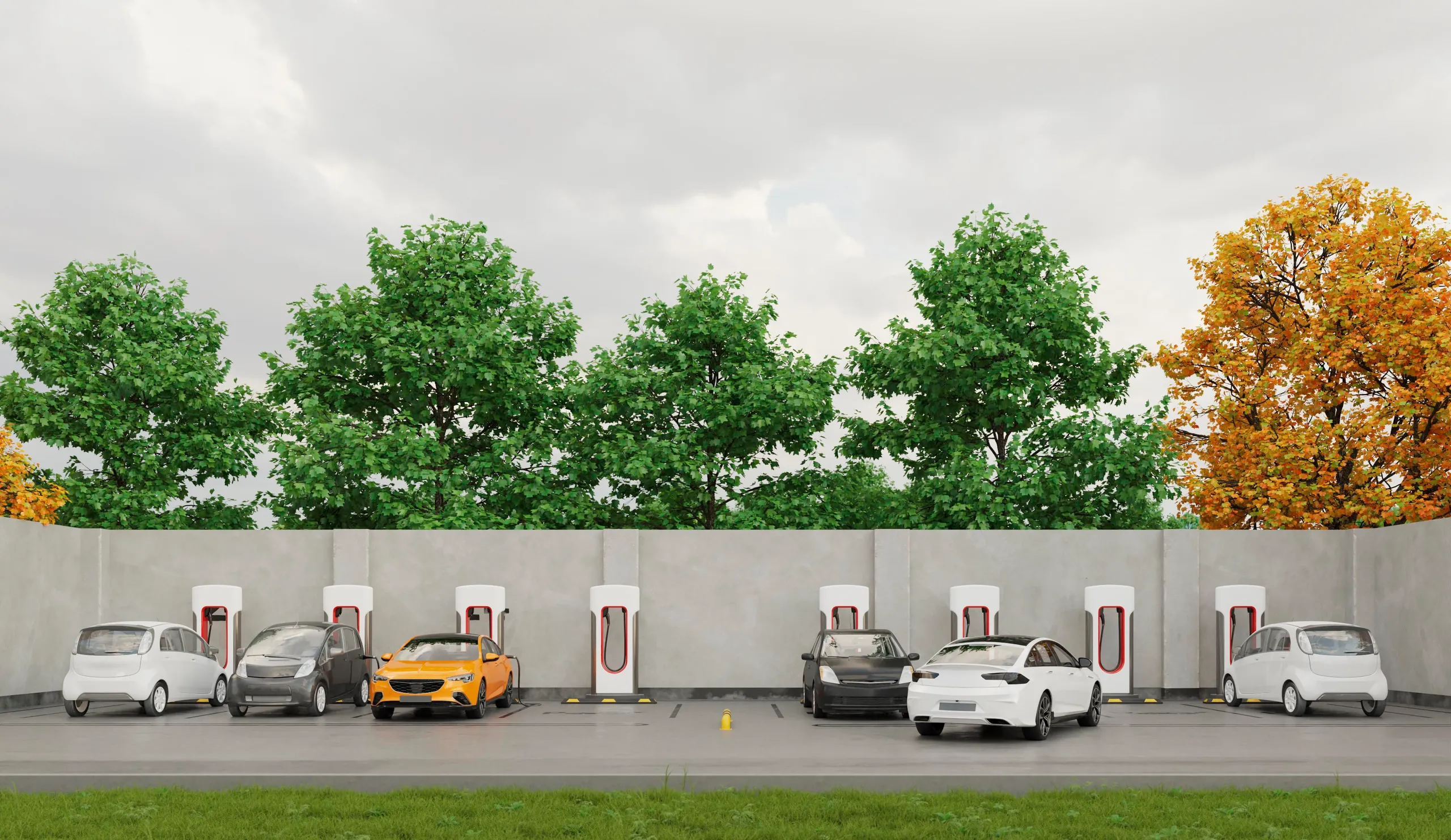 Varios coches eléctricos de diferentes colores cargando en estación pública junto