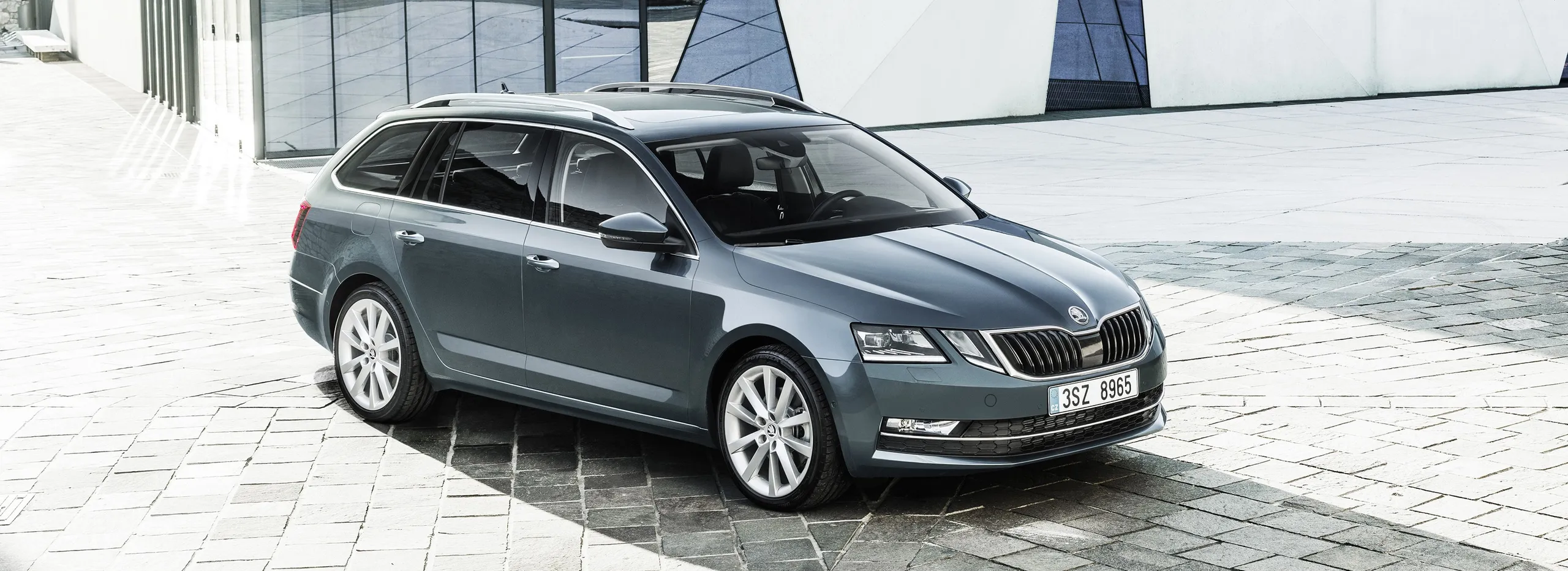 Skoda Octavia Combi gris en vista lateral sobre pavimento de piedra